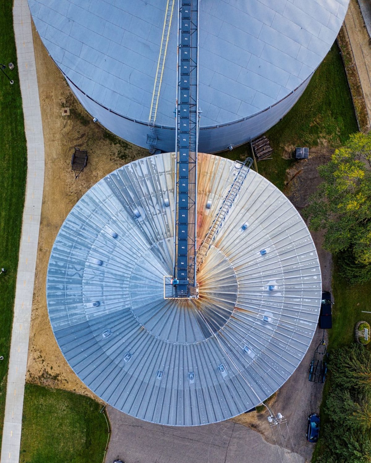 Overhead aerial view of grain storage bins and a conveyor gallery